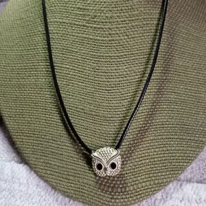 Silvertone white owl on black cord with black eyes necklace